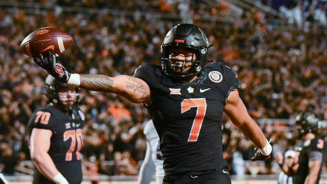 Oklahoma State running back Jaylen Warren (7) celebrates following his touchdown during the first half of the team’s NCAA college football game against TCU on Saturday, Nov. 13, 2021, in Stillwater, Okla. (AP Photo/Brody Schmidt)