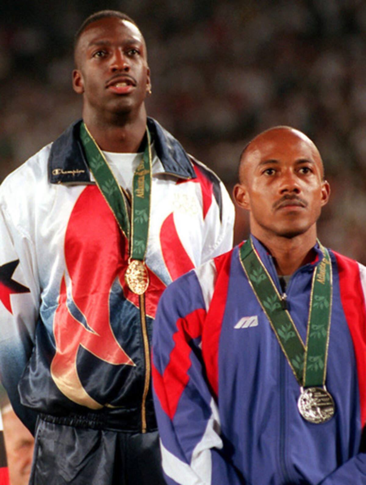 FILE - This is a Thursday Aug. 1, 1996 file photo of Frankie Fredericks of Namibia, right, wearing his silver medal with Michael Johnson of the United States, wearing his gold medal, during the presentation ceremony for the men’s 200 meters at the 1996 Summer Olympic Games in Atlanta. Former Olympic sprinter Frankie Fredericks has turned himself over to the IOC ethics commission following a French newspaper report linking him to a payment from a man who has been banned for life from track and field for corruption. Le Monde reported Friday March 3, 2017, that a payment of $299,300 to an offshore company linked to Fredericks came in 2009 on the day that Rio de Janeiro was awarded hosting rights for the 2016 Olympics. (AP Photo/Eric Draper/File )