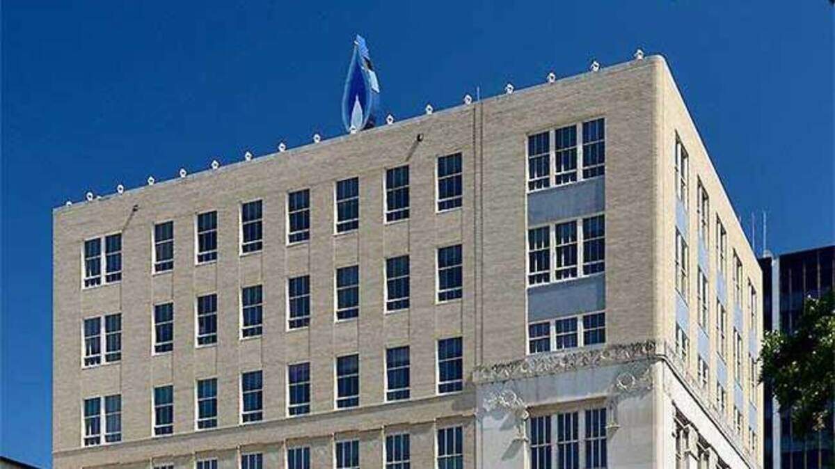 The iconic blue flame atop the former Lone Star Gas building as been removed for restoration.