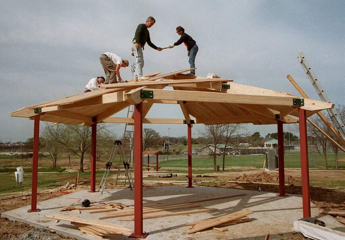 March 16, 1999: Paul Huff, John Tompkins, Larry Abernathy and Nancy McClanahan work on the last pavilion at Bicentennial Park in Southlake. Volunteers from the Adventure Alley Pavilion Committee are working to complete the project.