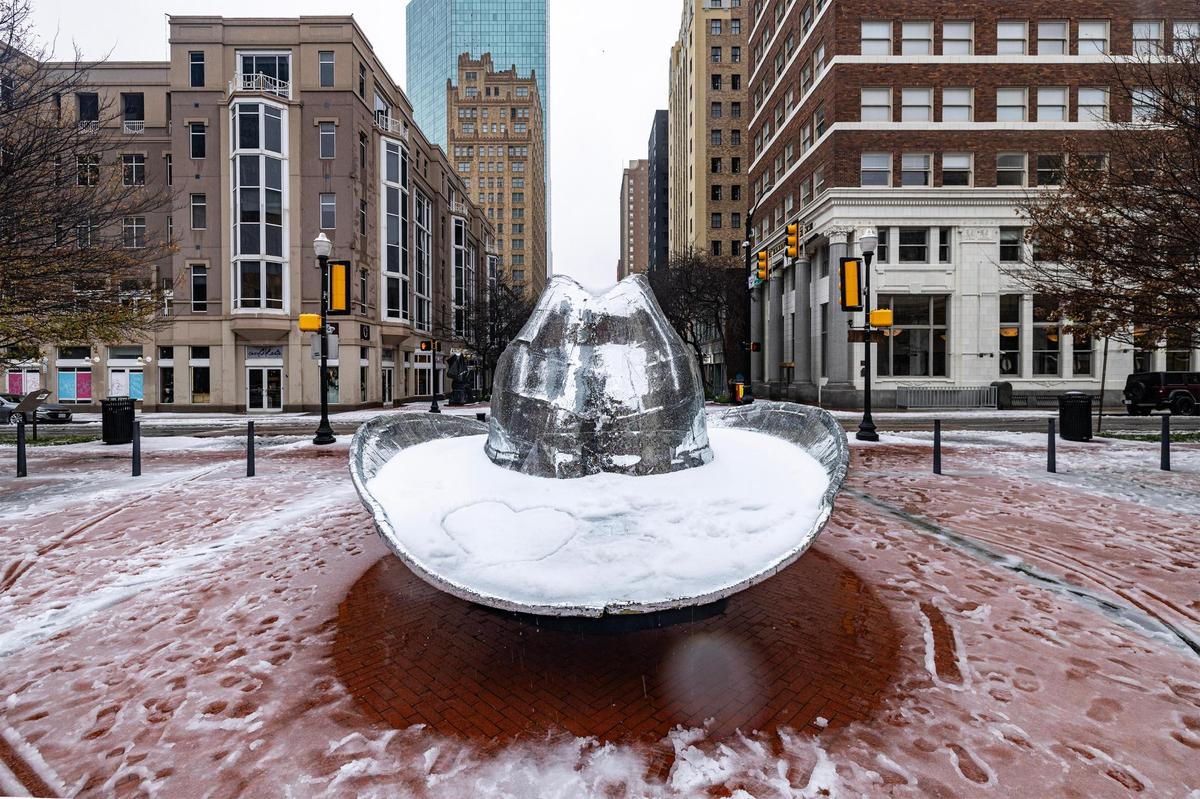 A heart is traced in the snow gathered inside the silver cowboy hat at Sundance Square in downtown Fort Worth on Thursday, Jan. 9, 2025.