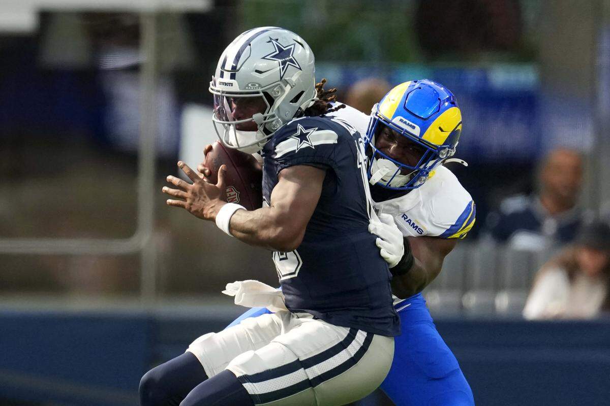 Aug 9, 2025; Inglewood, California, USA; Dallas Cowboys quarterback Joe Milton III (10) is sacked by Los Angeles Rams linebacker Josaiah Stewart (41) in the first half at SoFi Stadium. Mandatory Credit: Kirby Lee-Imagn Images