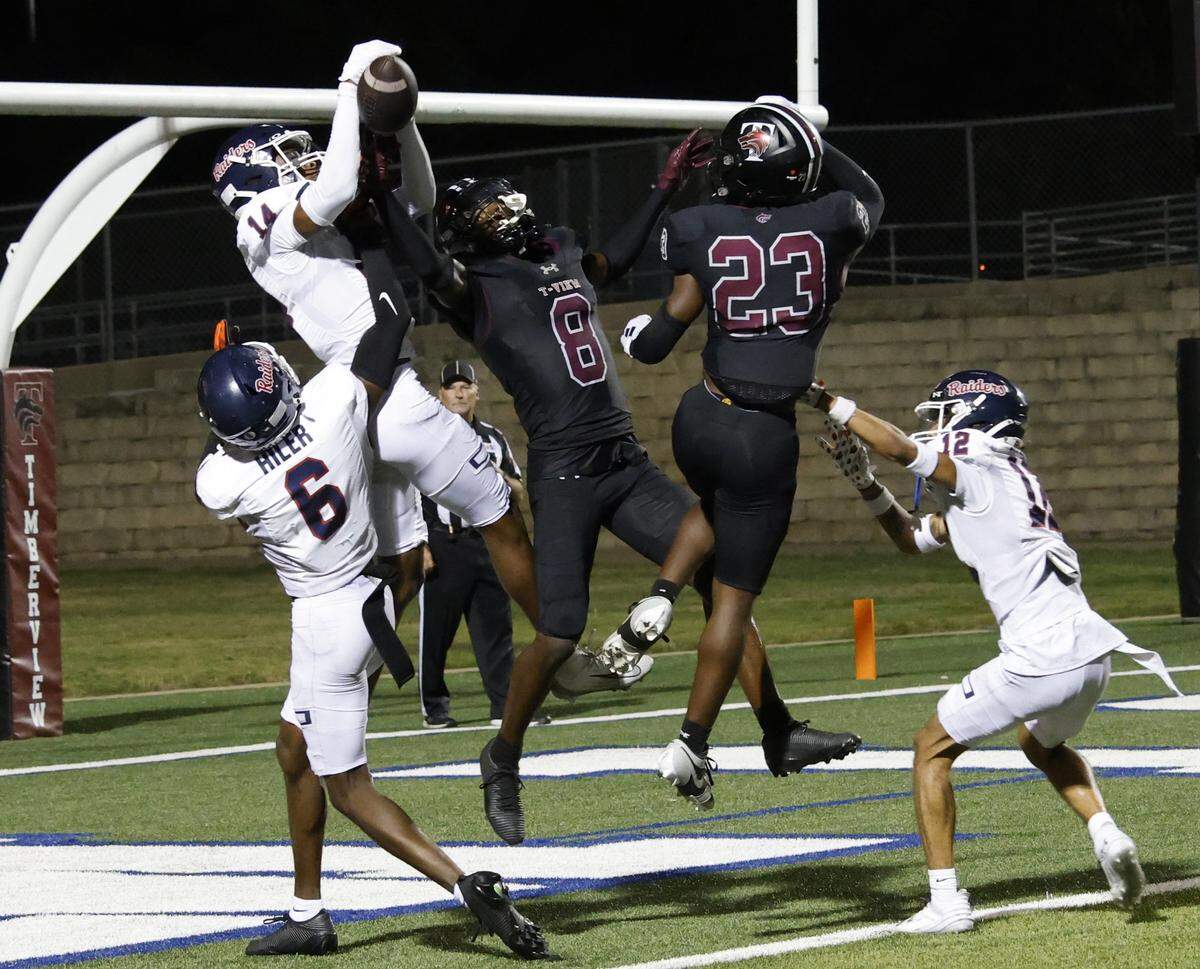 Ryan defensive back Chris Pace (14) knocks down a Hail Mary pass intended for Timberview wide receiver Chance Collins (8) during the second half of a UIL football game at Vernon Newsom Stadium in Mansfield, Texas, Thursday, Sept. 04, 2025.