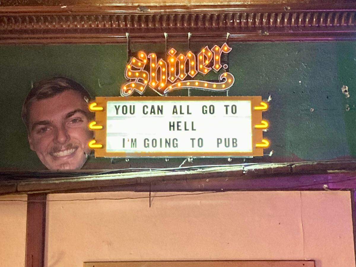 The walls inside The Pub on University Ave. in Fort Worth are loaded with signs that now look vintage.