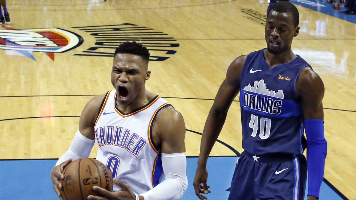 Oklahoma City Thunder guard Russell Westbrook (0) reacts to a dunk by a teammate in front of Dallas Mavericks forward Harrison Barnes (40) in the first half of an NBA basketball game in Oklahoma City, Monday, Dec. 31, 2018. (AP Photo/Sue Ogrocki)