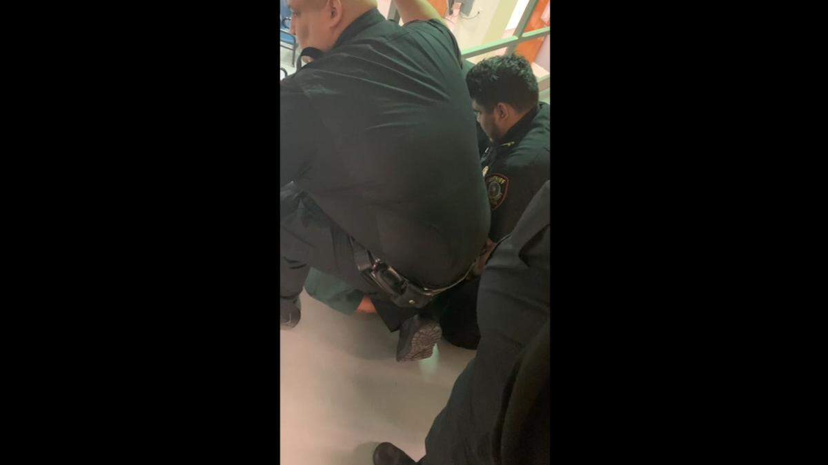A screenshot of the video leading up to Anthony Johnson Jr.’s death shows a Tarrant County detention officer identified as Rafael Moreno putting his knee on Johnson’s back after he was restrained. Moreno and Lt. Joel Garcia were fired for the action and face murder charges.