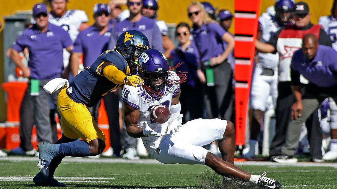 TCU wide receiver Savion Williams (18) catches a pass as West Virginia cornerback Wesley McCormick (11) defends during the first half of an NCAA college football game in Morgantown, W.Va., Saturday, Oct. 29, 2022. (AP Photo/Kathleen Batten)