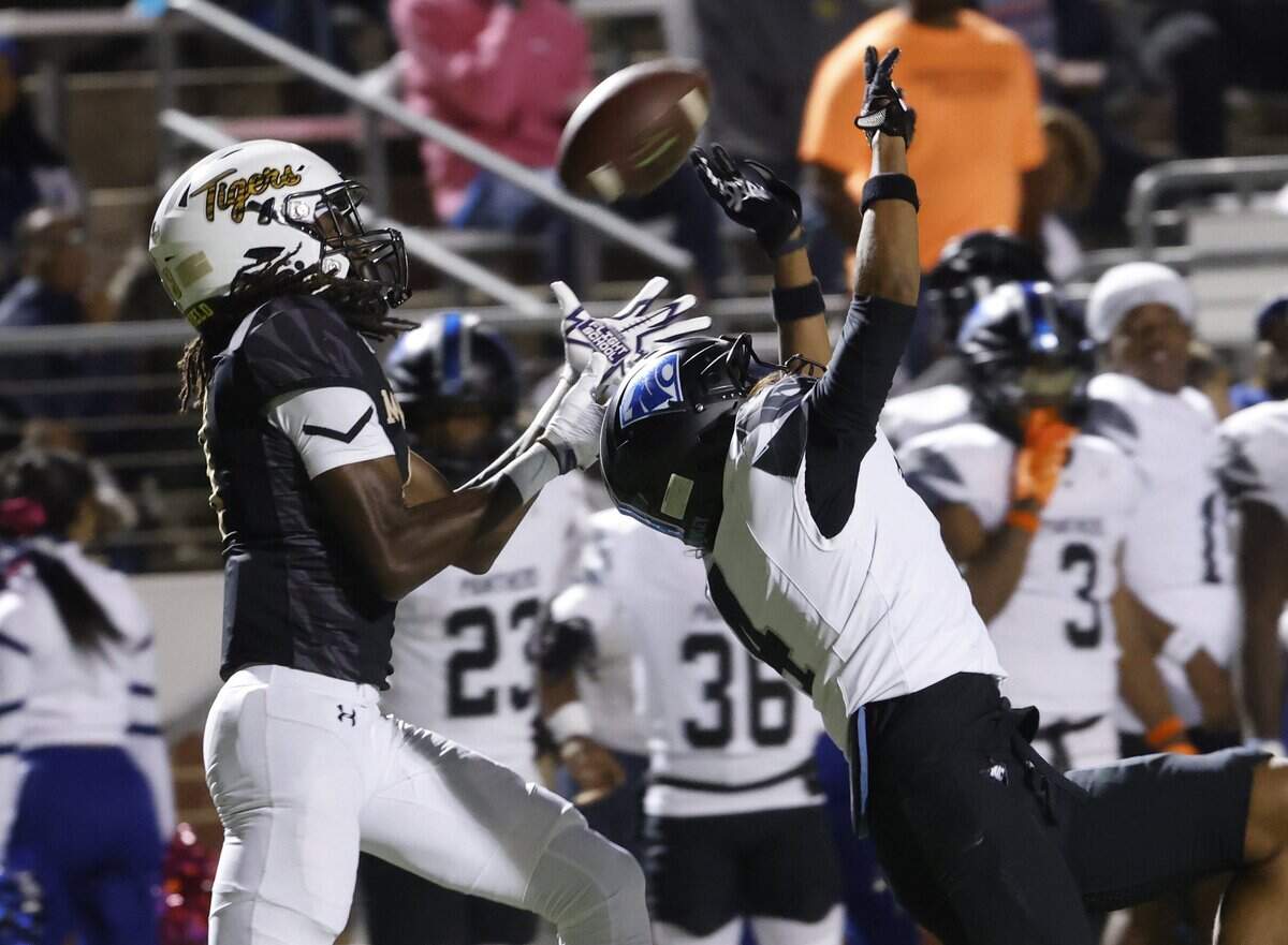Mansfield wide receiver Zion Robinson (8) makes a touchdown catch covered by North Crowley corner back Jerry Outhouse (4) during the first half of a UIL football game between North Crowley and Mansfield at Vernon Newsom Stadium in Mansfield, Texas, Thursday, October, 30, 2025.