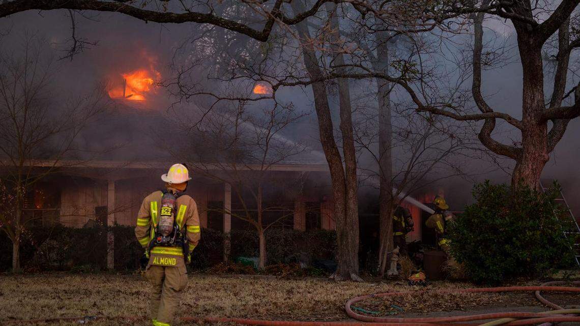 Grand Prairie firefighters battle a house fire on Thursday morning.
