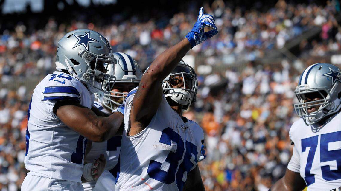 Dallas Cowboys running back Tony Pollard, center, celebrates his touchdown with teammates during the first half of a preseason NFL football game against the Los Angeles Rams on Saturday, Aug. 17, 2019, in Honolulu. (AP Photo/Mark J. Terrill)