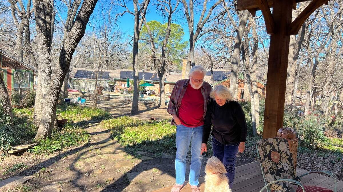 David Coulter and Shelley Cushman with their dog George under a gazebo they added to their property, which they believe might have triggered an inspection request from the Denton Central Appraisal District.