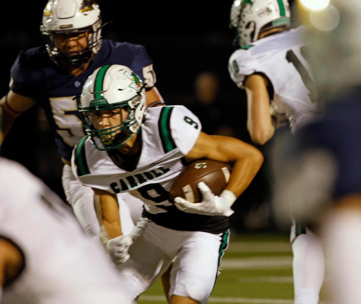 Carroll running back Riley Wormley (9) brings the ball through the crowd in the first half of a UIL football game at Keller ISD Stadium in Keller, Texas, Thursday, Oct. 05, 2023. Carroll led Keller 35-0 at the half. (Special to the Star-Telegram Bob Booth)