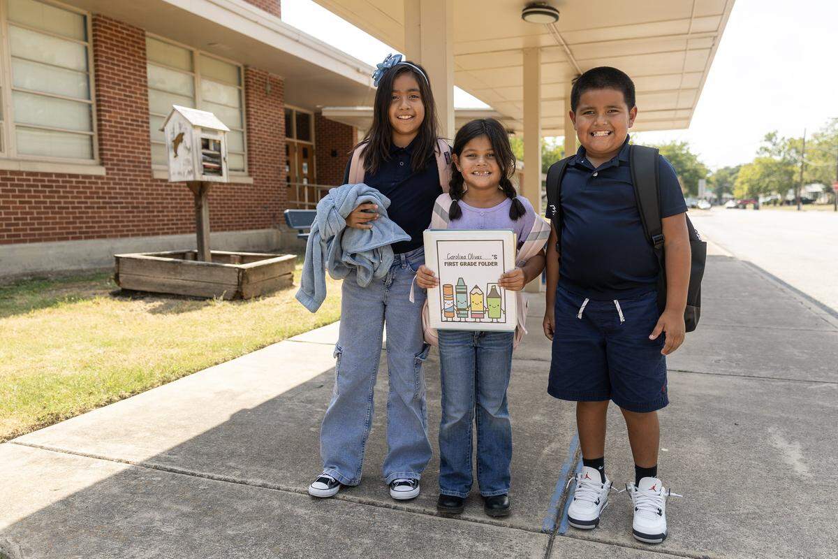 Siblings Camila, 9, Carolina, 6, and Cameron Olivas, 8, are photographed after school gets out at Riverside Applied Learning Center in Fort Worth on Tuesday, Aug. 19, 2025.