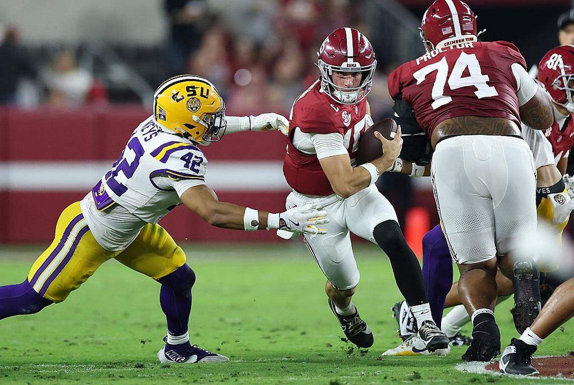 TUSCALOOSA, ALABAMA - NOVEMBER 08: Ty Simpson #15 of the Alabama Crimson Tide rushes away from Davhon Keys #42 of the LSU Tigers during the first quarter at Bryant-Denny Stadium on November 08, 2025 in Tuscaloosa, Alabama. (Photo by Kevin C. Cox/Getty Images)