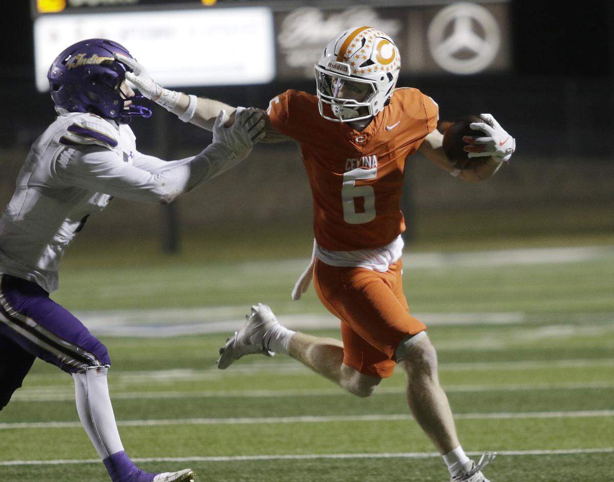 Celina’s Jacob Brown stiff arms a defender during their Class 4A Division I quarter final game at Newsom Stadium on Friday, December 5, 2025, in Mansfield, Texas.