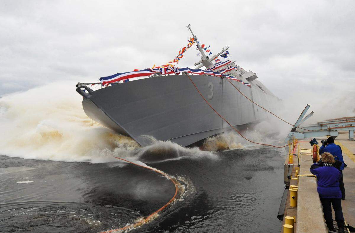 The U.S. Navy’s USS Fort Worth, a littoral combat ship, slides into the Menominee River during its launch at Marinette Marine in Marinette, Wis. on Saturday, Dec. 4, 2010. (AP Photo/The Marinette EagleHerald, Rick Gebhard) ORG XMIT: WIMAR101