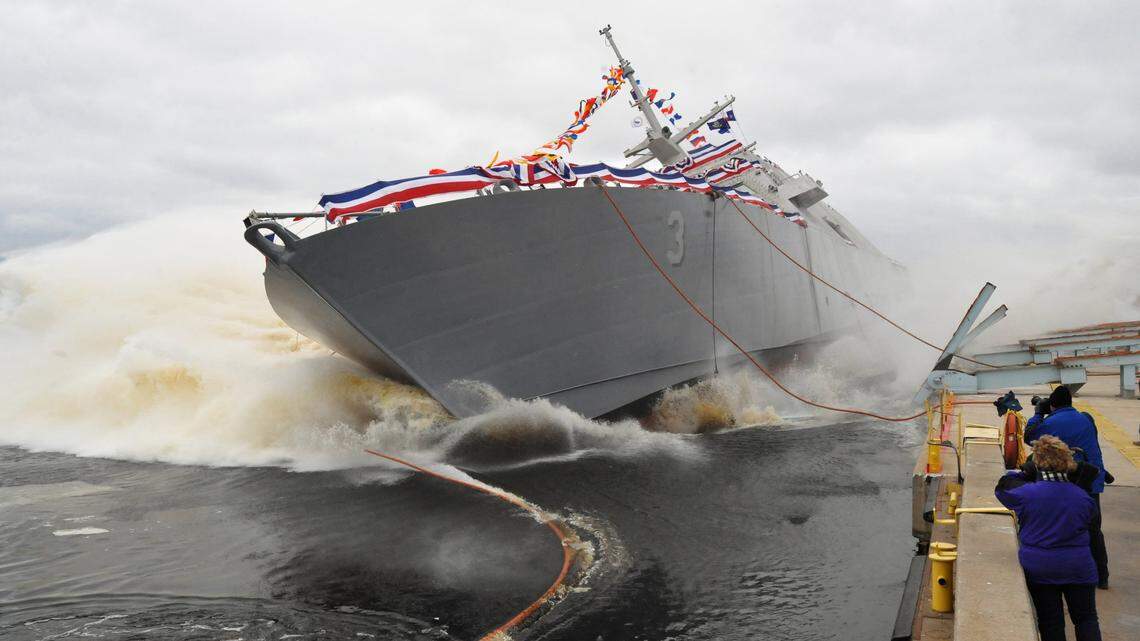 The USS Fort Worth slides into the Menominee River during its launch in Marinette, Wis., on Dec. 4, 2010.