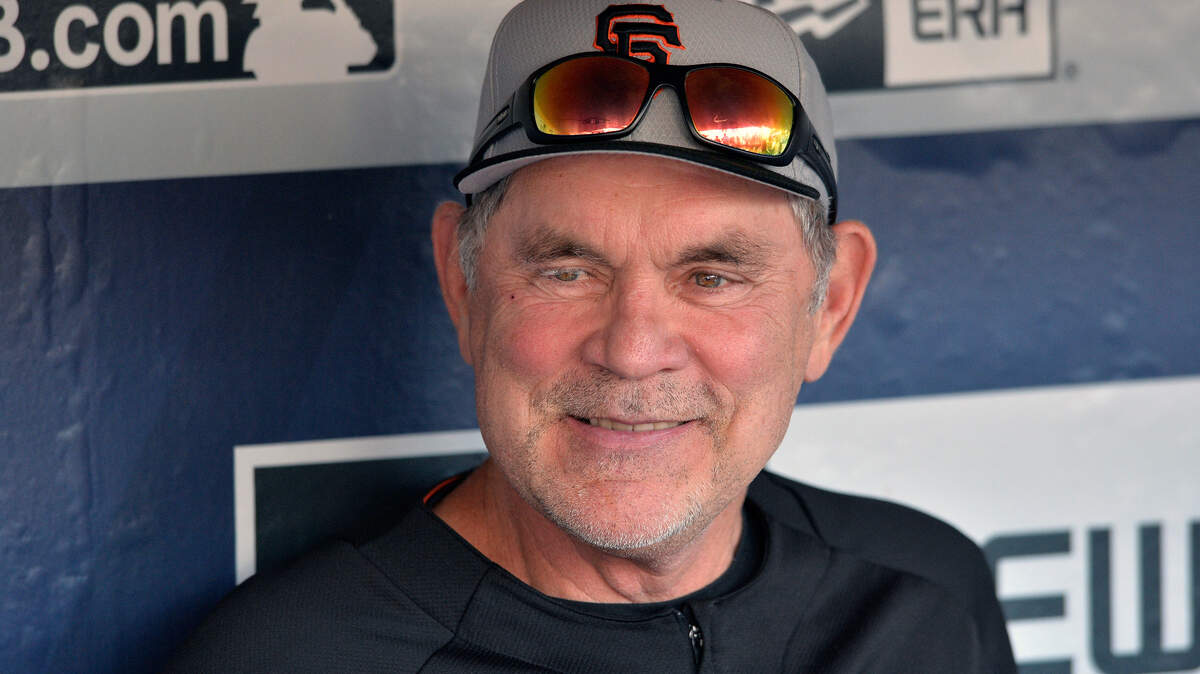 FILE - San Francisco Giants’ Bruce Bochy looks on from the dugout before a baseball game against the San Diego Padres on Friday, July 26, 2019, in San Diego. The Texas Rangers have hired Bruce Bochy as their new manager, bringing the three-time World Series champion out of retirement to take over a team that has had six consecutive losing seasons. Texas made the surprise announcement Friday, Oct. 21, 2022, just more than two weeks after its season ended. (AP Photo/Orlando Ramirez, File)