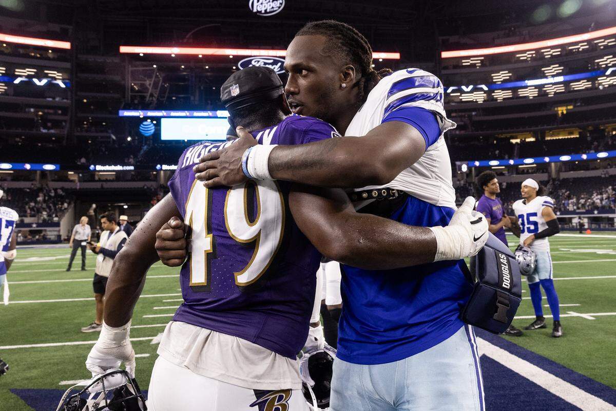 Ravens linebacker Jay Higgins IV (49) embraces Cowboys quarterback Joe Milton (10) after an NFL preseason game between the Dallas Cowboys and the Baltimore Ravens at AT&T Stadium in Arlington on Saturday, Aug. 16, 2025,