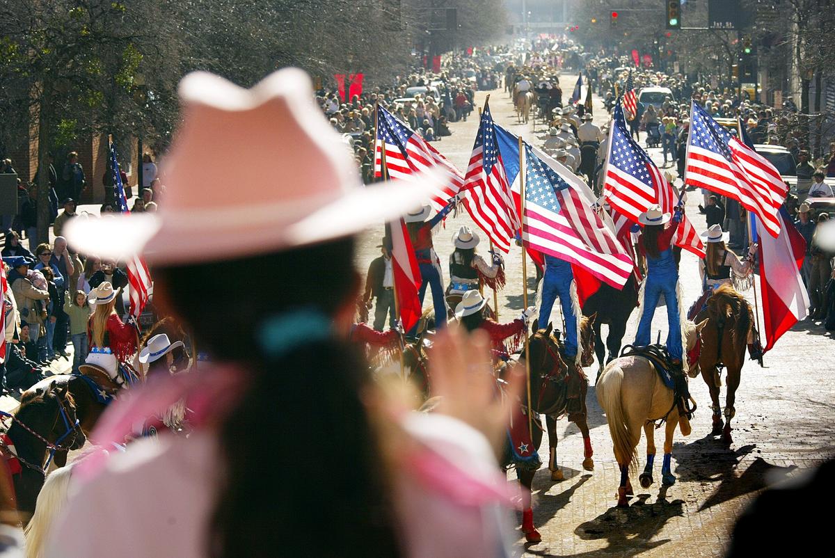 Jan. 15, 2005: A girl waves to the parade as thousands of people lined Main Street in downtown Fort Worth for the annual Southwestern Exposition and Stock Show parade.