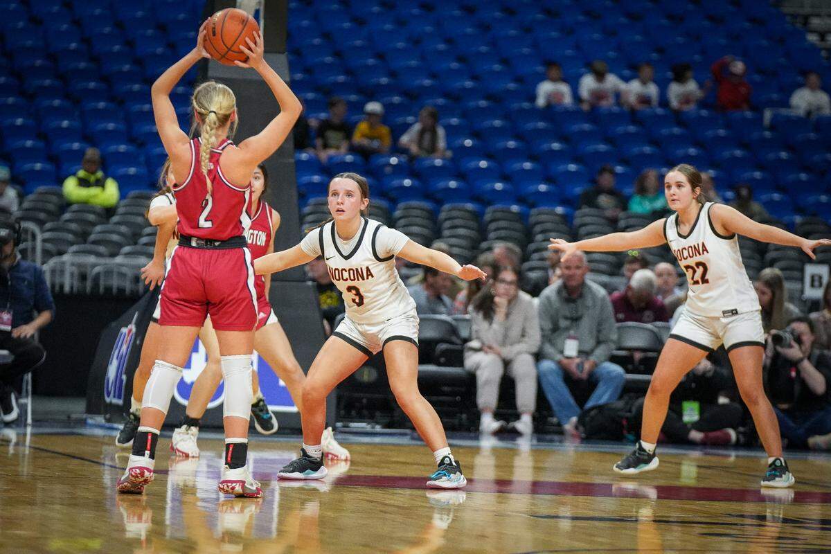 Wellington’s Presley Kane (2) looks to get the ball inside as Reagan Phipps (3) and Aubree Kleinhans (22) of Nocona help guard the paint in a Class 2A state semifinal on Friday, March 1, 2024 at the Alamodome in San Antonio, Texas. Nocona rallied to win 44-42.
