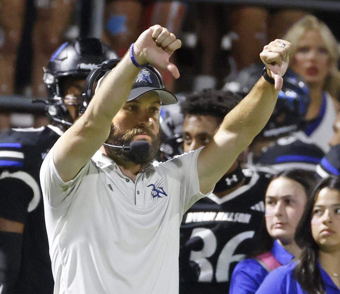 Byron Nelson head coach Zach Woodward sends in defensive signals during the second half of a UIL football game between Southlake Carroll  and Byron Nelson at Northwest ISD Stadium in Justin, Texas, Friday, Sept. 12, 2025.