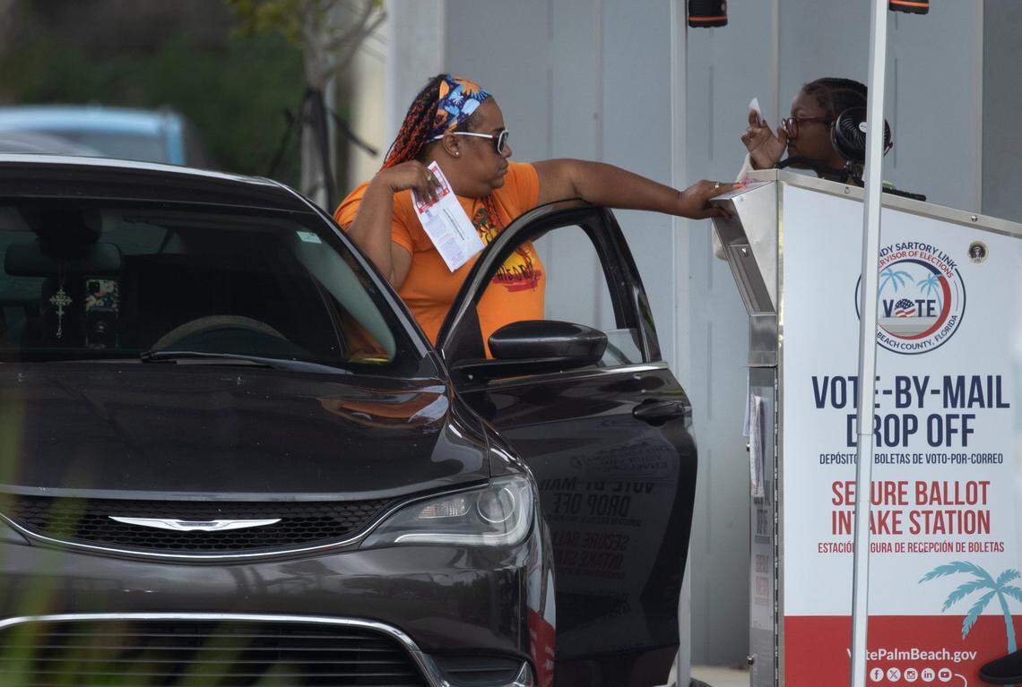 A voter drops off her Vote-By-Mail ballot at the Palm Beach County Supervisor of Elections office on Nov. 5, 2024, in West Palm Beach, Florida.