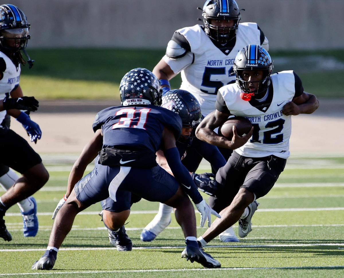 North Crowley quarterback Chris Jimerson (12) cuts to the outside to avoid the tackle of Allen defensive back Camden Clark (31) during the second half of a UIL Conference 6A Division 1 quarterfinal football playoff game at Dragon Stadium in Southlake, Texas, Saturday, Dec. 02, 2023.