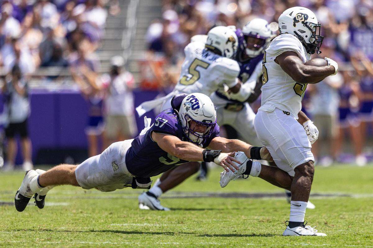 TCU linebacker Johnny Hodges (57) goes for a tackle on Colorado running back Sy’veon Wilkerson (36) during their game at Amon G. Carter Stadium in Fort Worth on Saturday.