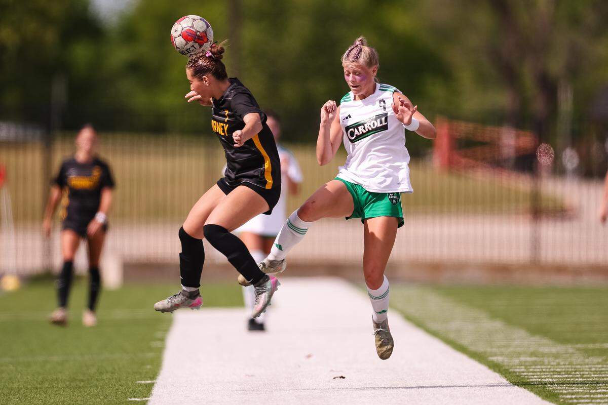 Southlake Carroll striker Caroline Holcombe (9) goes up for the ball as a Forney defender attempts to head the ball in a UIL Class 6A Division 2 girls soccer state semifinal on Saturday, April 4, 2026, at Memorial Stadium in Mesquite, Texas.