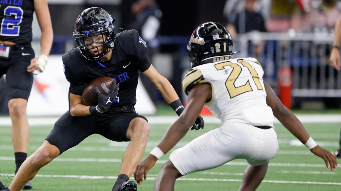 Gunter running back Brock Boddie (1) dodges the tackle of Woodville outside linebacker Adailius Williams (21) during the UIL 3A D2 State Championship football game at AT&T Stadium in Arlington, Texas, Thursday, Dec. 19, 2024.