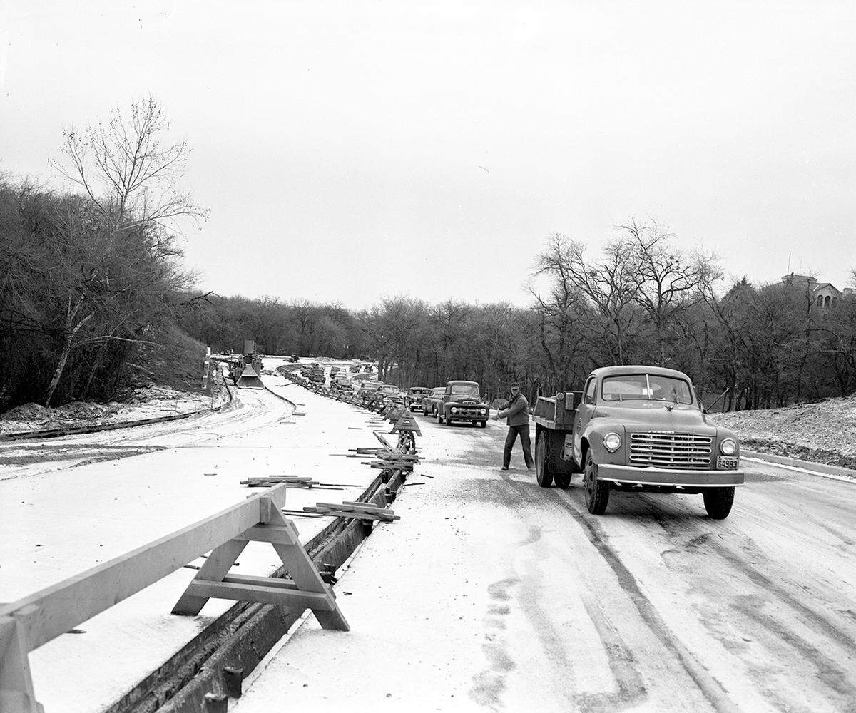 Jan. 16, 1953: “A city street department truck blazed a trail for motorists Friday morning, January 16, spreading gravel on University Drive at its south exit from Forest Park. A line of cars waited until traction could be obtained.”