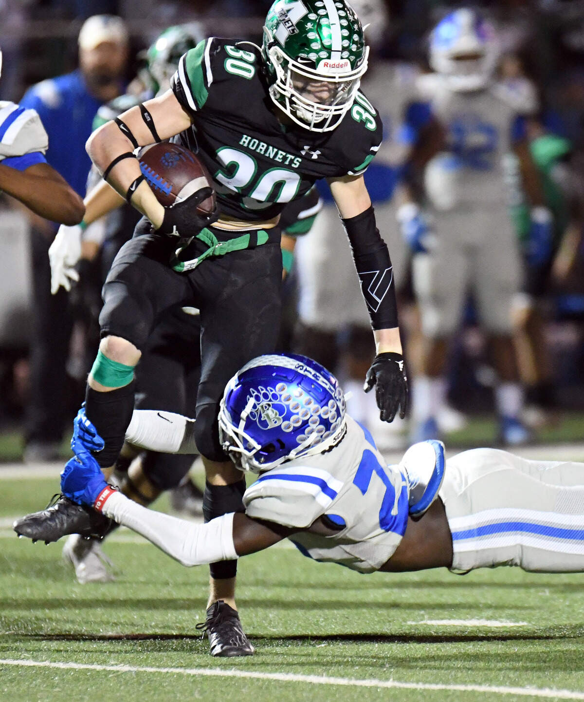 Azle’s Isaiah Fuller, left, is tripped up by Brewer’s Jordan Johnson-Rubell as he returns a kick in the second quarter of their district 3-5A Division 1 football game Friday, October 22, 2021 at Hornet Stadium in Azle, Texas. Special/Bob Haynes