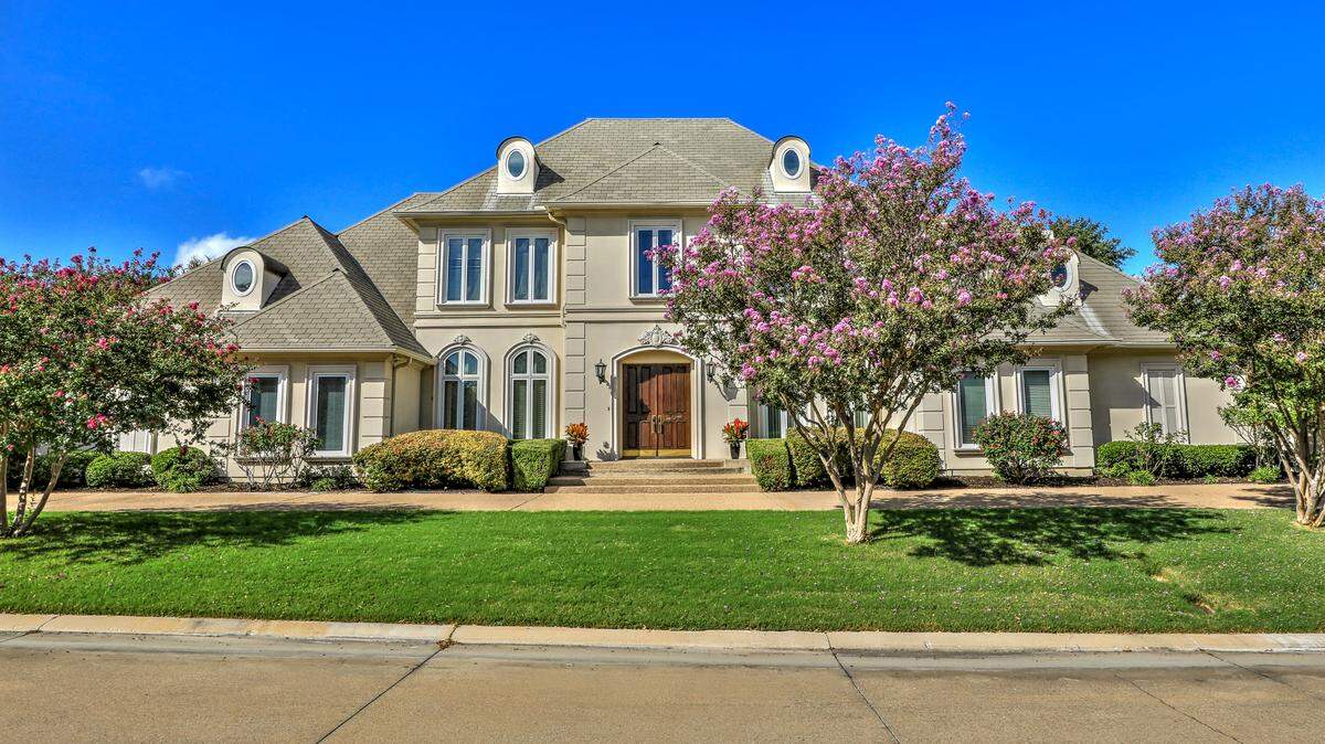 The home at 5792 Forest Highlands Drive with its circular drive and mature manicured landscaping create a stunning curb-appeal for any visitor.