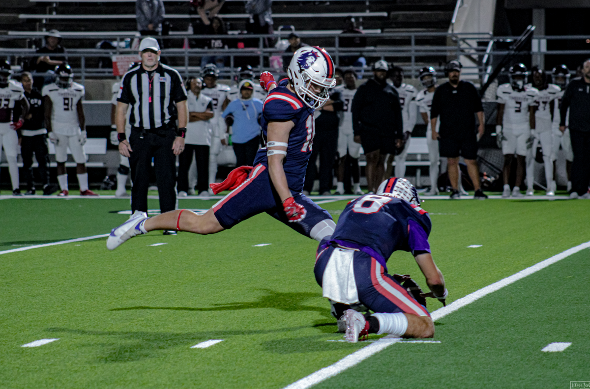 Richland kicker Beck Spivey (16) attempts a kick out of the hold of Drew Kates (8) against Mansfield Timberview on Friday, October 27, 2023 at Birdville Fine Arts/Athletics Complex in North Richland Hills, Texas.