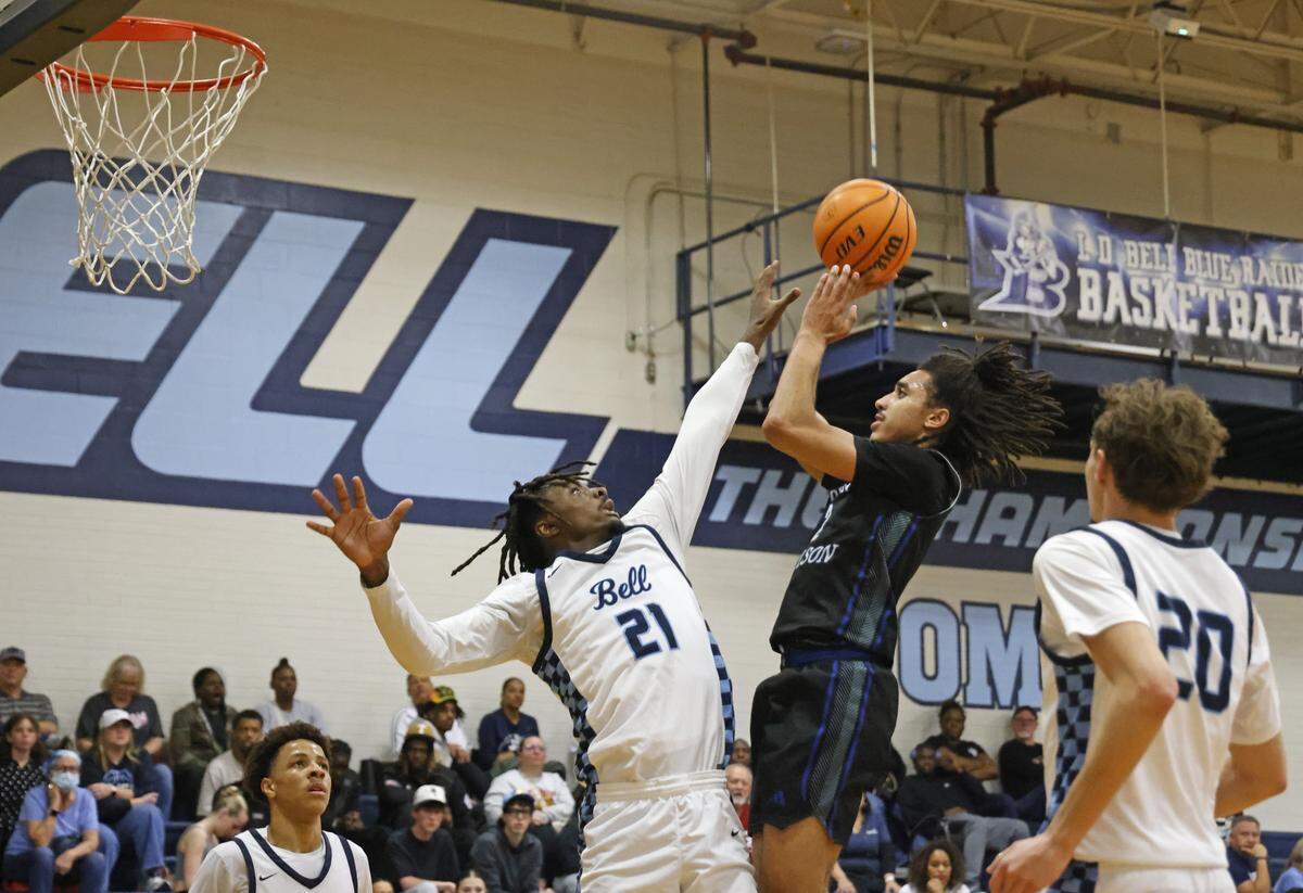 Byron Nelson guard Alex Jackson (2) gets two over the defense of L.D. Bell forward Imani Reynolds (21) during the second half of a boys UIL basketball game between Byron Nelson and L.D. Bell at L.D. Bell High School in Hurst, Texas, Friday Feb. 06, 2026