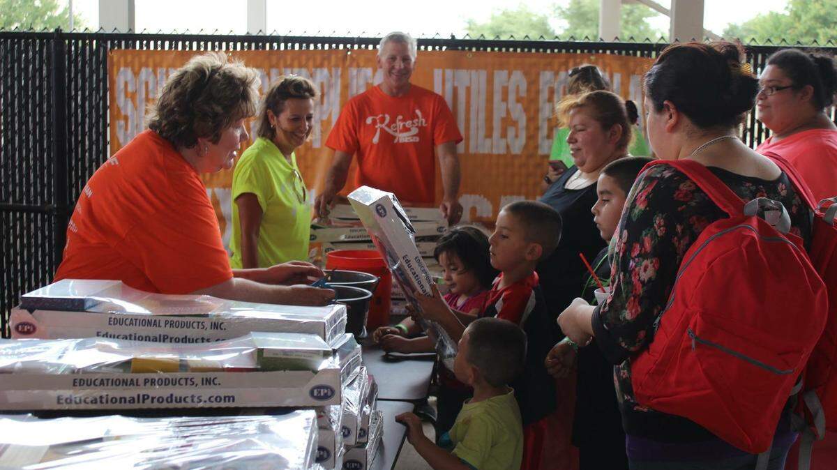 Volunteers at Refresh BISD Back to School Health Fair help students receive free backpacks and school supplies, along with other help such as athletic physicals, haircuts and eye exams.