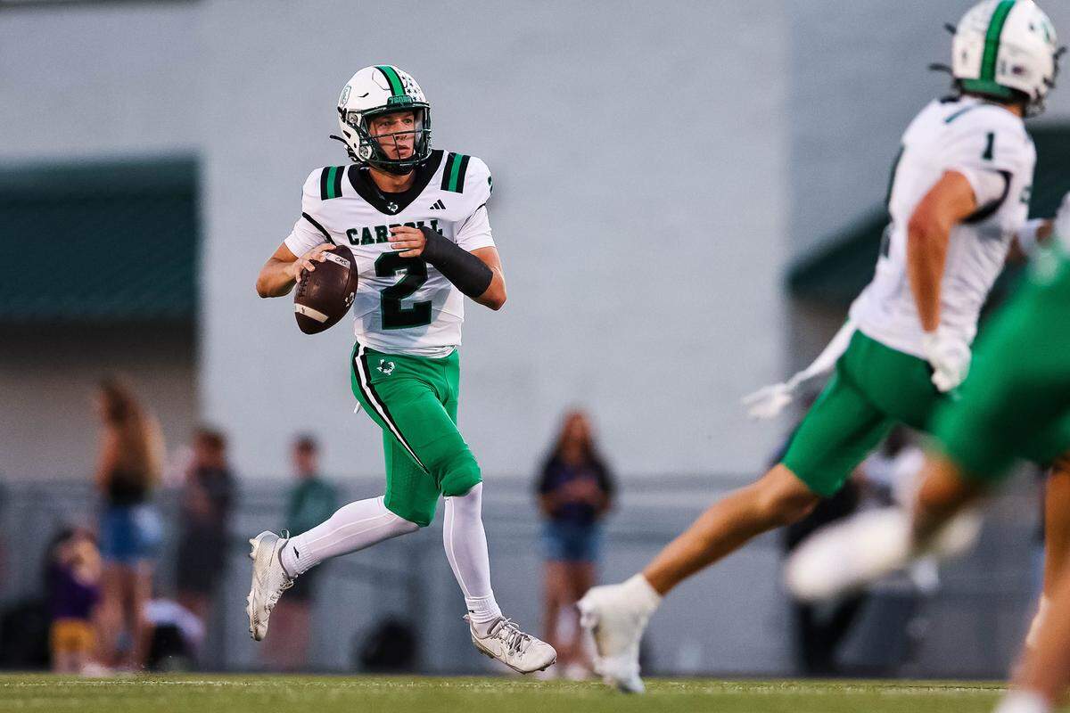 Southlake Carroll quarterback Angelo Renda runs with the football looking downfield to a wide receiver in a district matchup against Keller Timber Creek at Keller ISD Stadium on Thursday, Sept. 25, 2025.