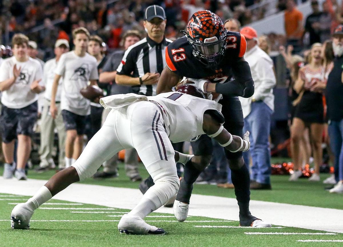 Aledo wide receiver Monty Parks (13) tries to break free from Ennis cornerback Dan’tron Brown (L) after a making a reception during the first half of the 5A Division II State quarterfinal high school football playoff game played at the Ford Center in Frisco, TX Friday, December 6, 2019.