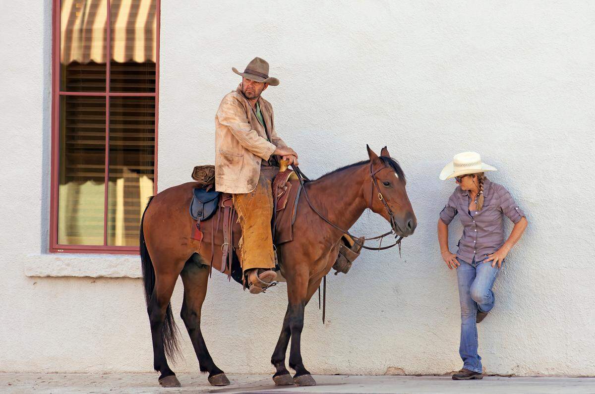 An extra on a horse waits for filming of a scene to begin in “1883.”