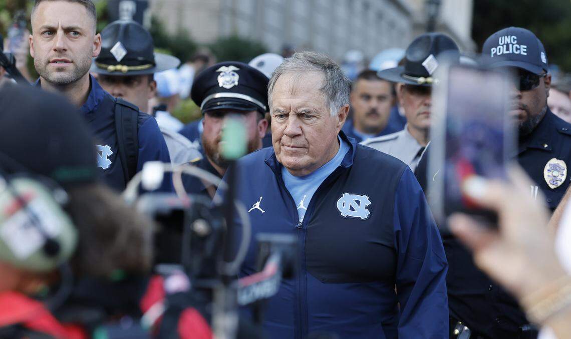 North Carolina head coach Bill Belichick walks towards Kenan Stadium during the Old Well Walk before UNC’s game against TCU in Chapel Hill, N.C., on Monday