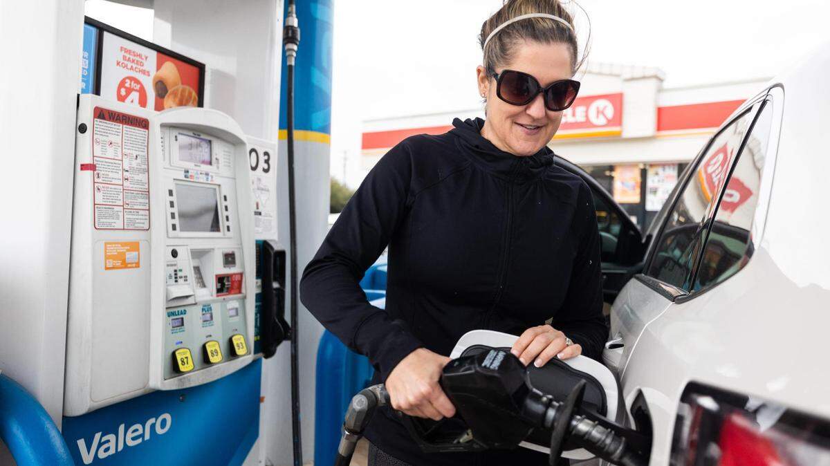 Kelley Currin pumps fuel at almost $4 per gallon on Monday, March 14, 2022, on Bryant Irving Road in Fort Worth.