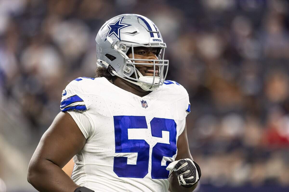 Cowboys right guard Tyler Booker (52) runs off the field in the first half of an NFL preseason game between the Dallas Cowboys and the Baltimore Ravens at AT&T Stadium in Arlington on Saturday, Aug. 16, 2025,