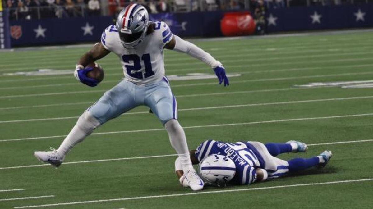 Dallas Cowboys’ Ezekiel Elliott (21) runs against Indianapolis Colts’ Rodney McLeod (26) during the second half of an NFL football game, Sunday, Dec. 4, 2022, in Arlington, Texas. (AP Photo/Ron Jenkins)