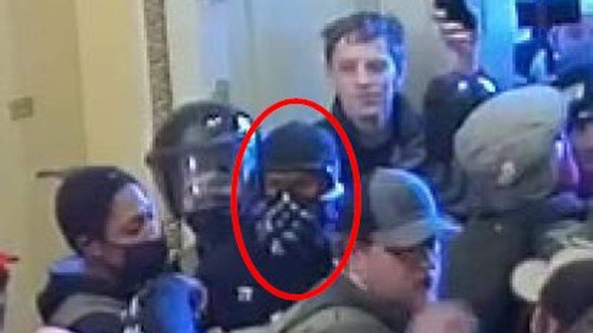 Nathan Pelham, of Greenville, Texas, pictured during the U.S. Capitol riot on Jan. 6, 2021, faces new charges after he was accused of shooting at law enforcement officers outside his home, according to federal authorities.