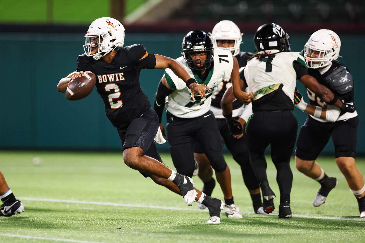 Arlington Bowie quarterback Jayden Bibbs escapes from the Berkner defense while running with the ball in a bi-district playoff game at Choctaw Stadium in Arlington, Texas on Nov. 14, 2025.