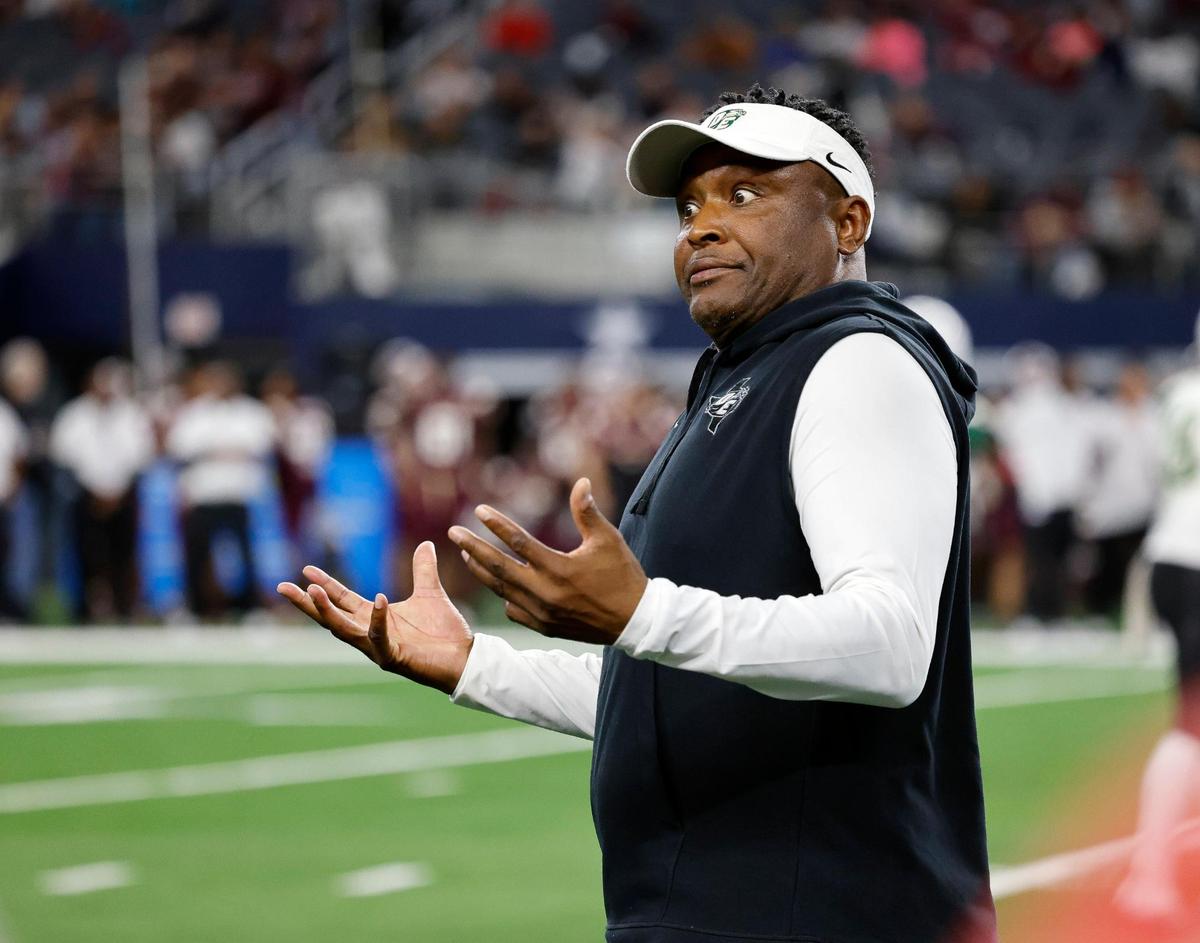 DeSoto head coach Claude Mathis attempts to get a time out with a minute remaining during the second half of the UIL Conference 6A Division 2 state championship football game at AT&T Stadium in Arlington, Texas, Saturday, Dec. 16, 2023.