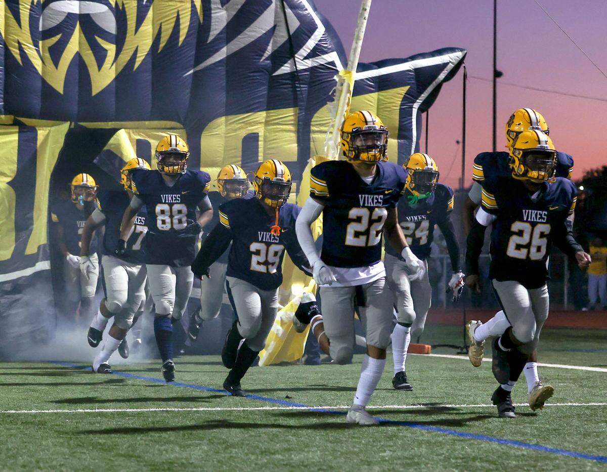 The Arlington Lamar Vikings enter the field to face South Grand Prairie in a District 8-6A high school football game played at Cravens Field on Thursday, November 4, 2021, in Arlington. (Steve Nurenberg/Special to the Star-Telegram)