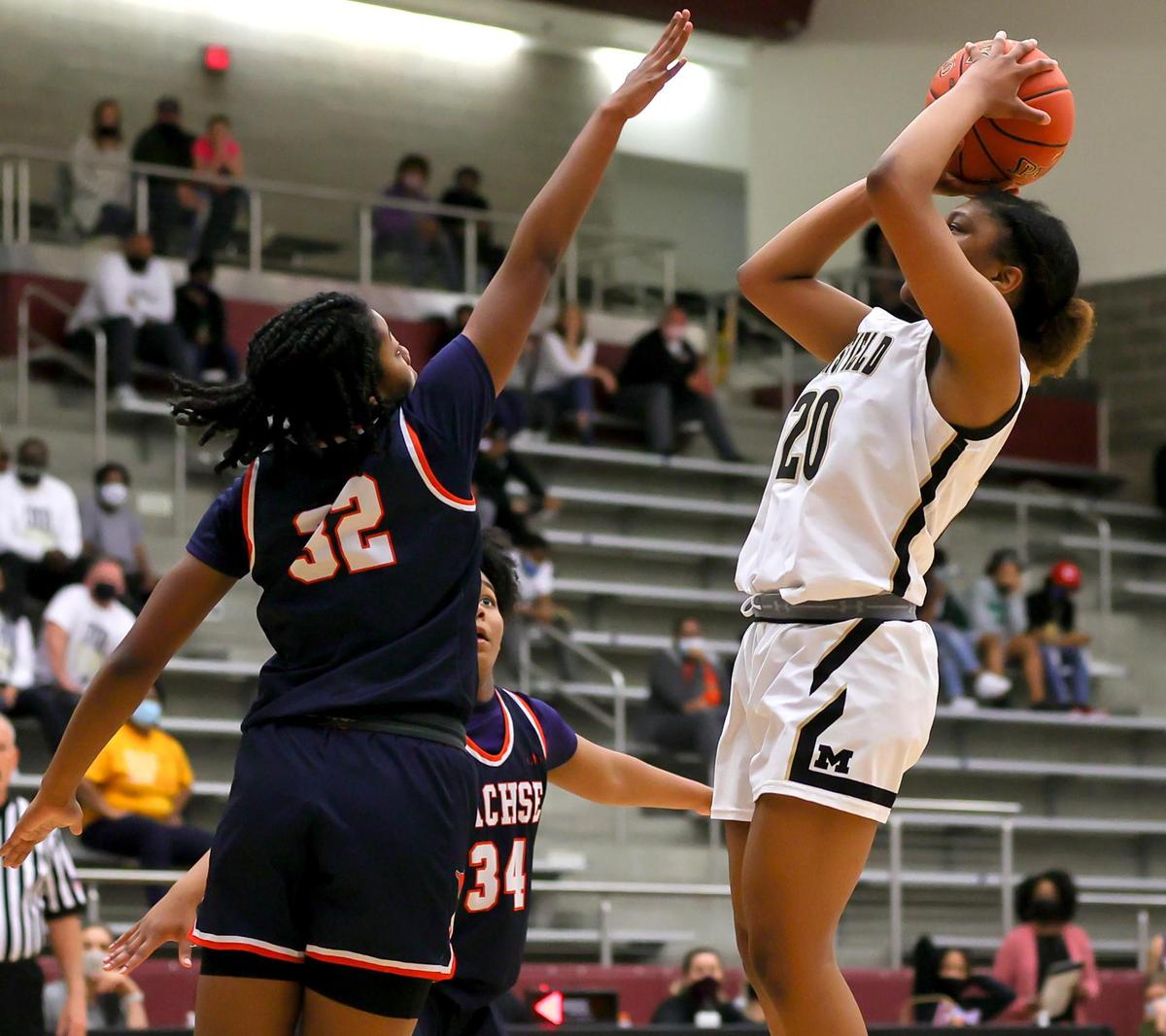 Mansfield guard Kendyl Howell (20) tries to get off a shot over Sachse guard Micah Cooper (32) during the second half of the 6A Region II Girls Basketball Area -Round 2 played February 23, 2021 at Lewisville High School. (Steve Nurenberg Special to the Star-Telegram)