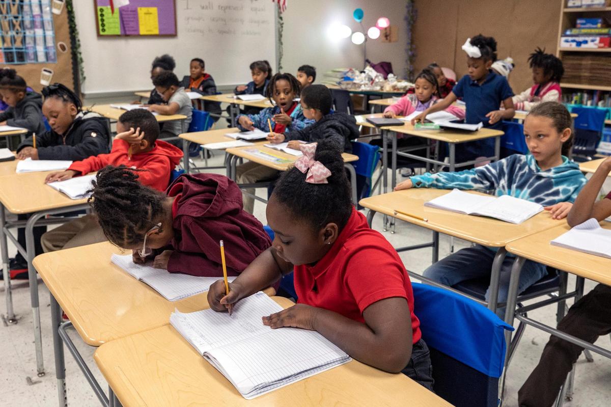 Second-grade students take notes during class at David L. Walker Elementary in Fort Worth on Tuesday, Feb. 7, 2023. The new Accelerated Learning Academy at Walker extends both the school year and school days to prevent learning loss.